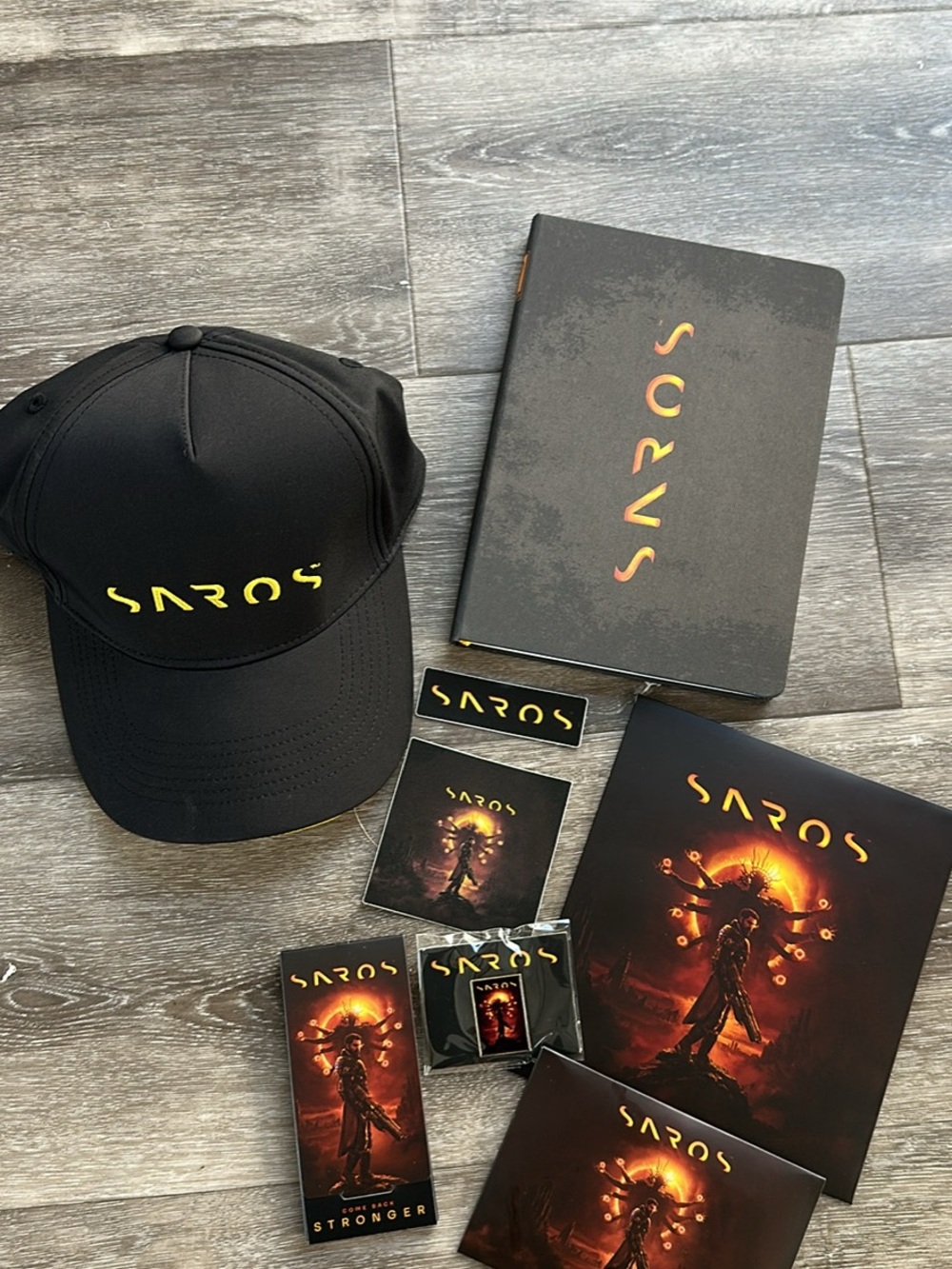SAROS Black Logo Cap & Merch Bundle — Black with Yellow/Orange Accents